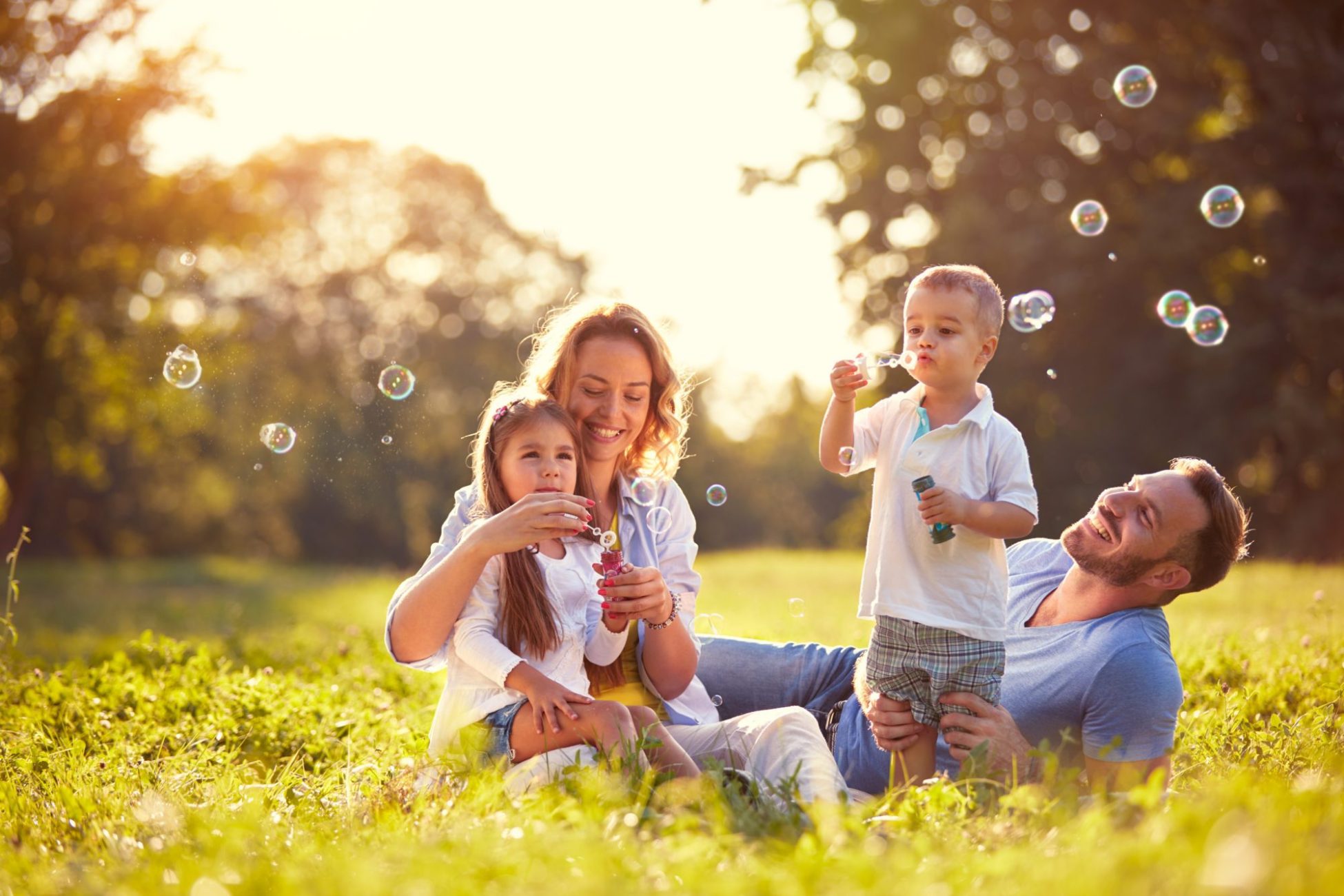 Family with children blow soap bubbles outdoor Family with children blow soap bubbles outdoor